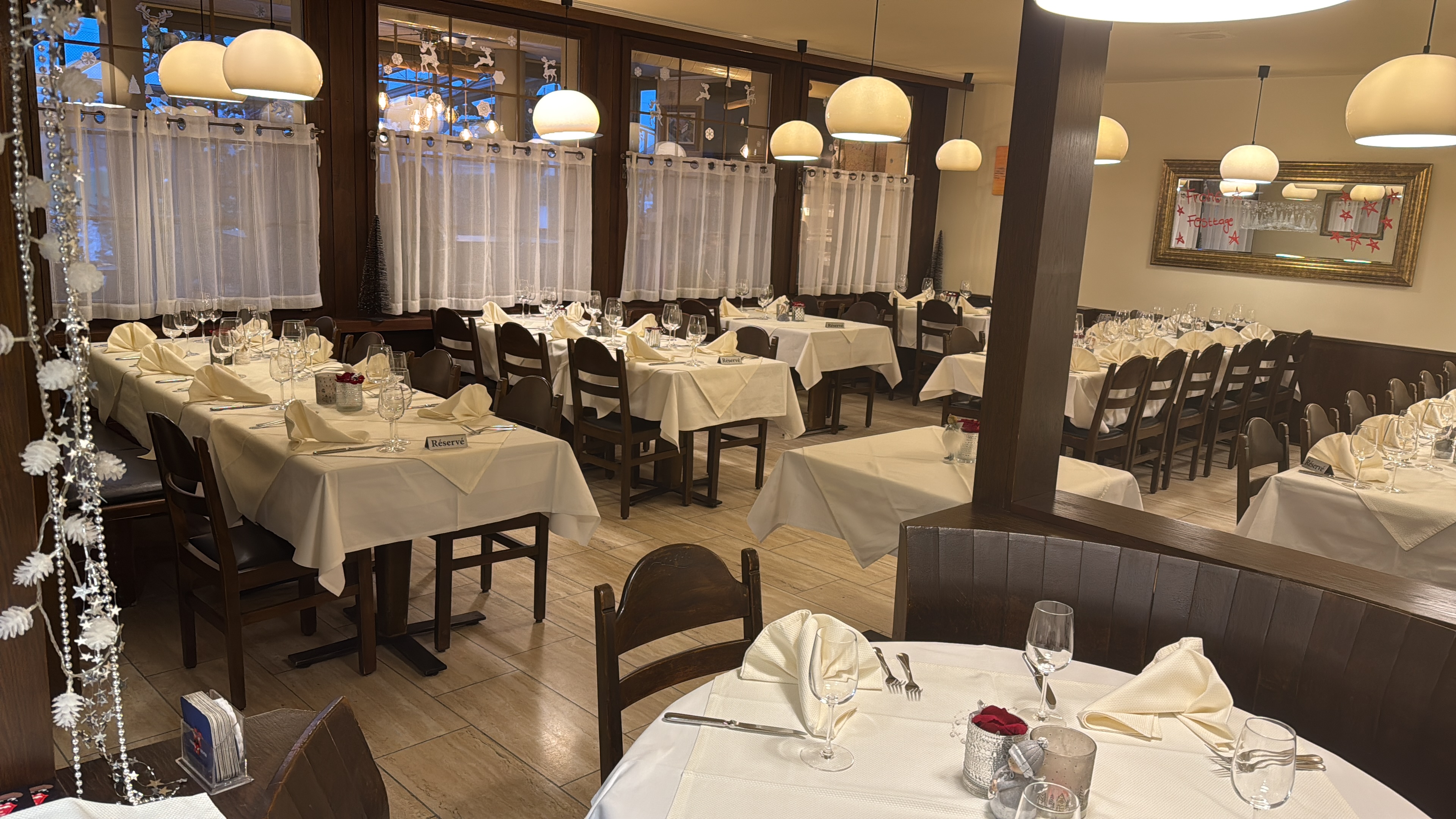 Gemütlicher Gastraum im Restaurant Erle mit gedeckten Tischen und warmer Beleuchtung